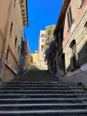 a set of stairs in an alley between two buildings at Beautiful Apartment in the Heart of Rome in Rome