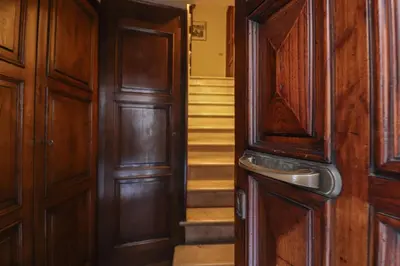 a hallway with wooden doors and stairs in a house at Beautiful Apartment in the Heart of Rome in Rome
