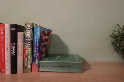 a stack of books sitting on a shelf at Beautiful Apartment in the Heart of Rome in Rome