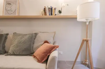 a lamp and a couch with pillows on it at Beautiful Apartment in the Heart of Rome in Rome