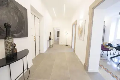 a hallway with white walls and a tile floor at Splendor Eternal 3 BR Apartment in the City Center in Rome