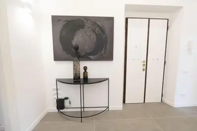 a room with a table and a painting on the wall at Splendor Eternal 3 BR Apartment in the City Center in Rome