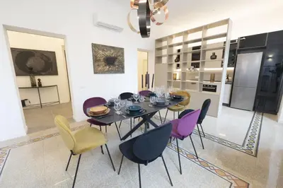 a dining room with a table and chairs at Splendor Eternal 3 BR Apartment in the City Center in Rome
