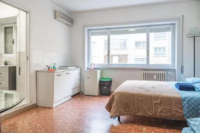 a bedroom with a bed and a sink and a window at Lion Renting Marconi in Rome