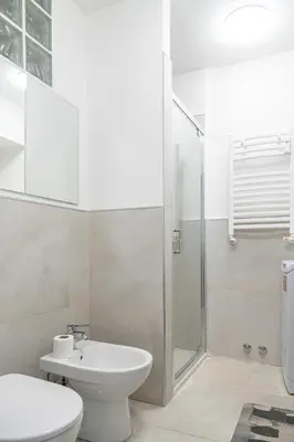 a bathroom with a toilet sink and a shower at Lion Renting Marconi in Rome