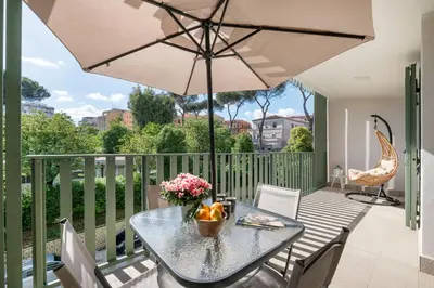 a patio with a table and an umbrella at Pigneto Terrace - Residenze Romanae in Rome