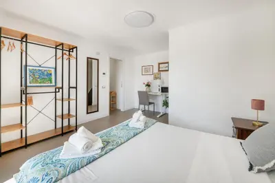 a bedroom with a large white bed with white pillows at Pigneto Terrace - Residenze Romanae in Rome