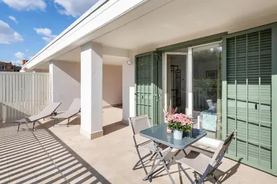 a patio with a table and chairs on a balcony at Pigneto Terrace - Residenze Romanae in Rome