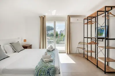 a bedroom with a large bed and a balcony at Pigneto Terrace - Residenze Romanae in Rome