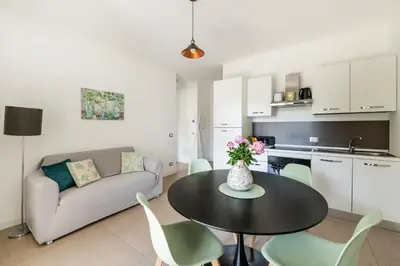 a kitchen and a living room with a table and a couch at Pigneto Terrace - Residenze Romanae in Rome
