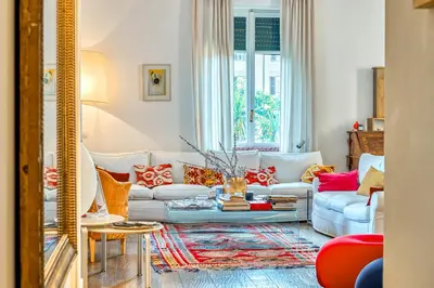 a living room with a couch and a table at Skylife Eco-Luxe Trastevere Haven in Rome