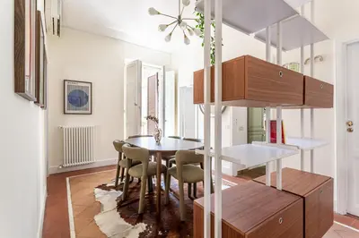 a kitchen and dining room with a table and chairs at iFlat Monti Life with Elegance, Comfort and Beauty in Rome