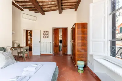 a living room with a bed and a table at iFlat Monti Life with Elegance, Comfort and Beauty in Rome