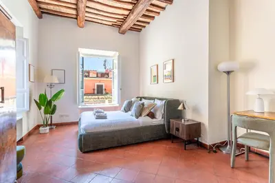 a living room with a bed and a window at iFlat Monti Life with Elegance, Comfort and Beauty in Rome
