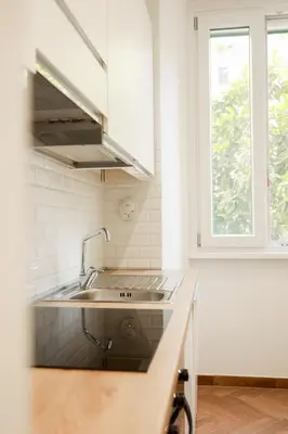 a kitchen with a sink and a window at La porta Magica, la casa tra le basiliche in Rome