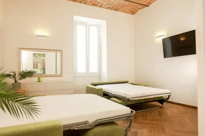 a hospital room with two beds and a flat screen tv at La porta Magica, la casa tra le basiliche in Rome