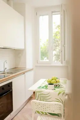 a kitchen with a table with a bowl of fruit on it at La porta Magica, la casa tra le basiliche in Rome
