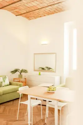 a living room with a table and a couch at La porta Magica, la casa tra le basiliche in Rome