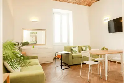a living room with a table and a couch at La porta Magica, la casa tra le basiliche in Rome