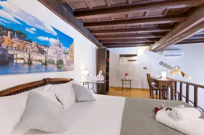 a bedroom with a bed with a painting on the wall at Loft Trastevere 2 floors in Rome