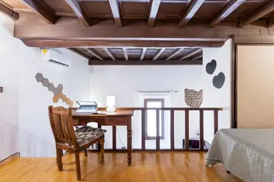 a room with a desk and a bed and a bed at Loft Trastevere 2 floors in Rome