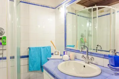 a bathroom with a sink and a glass shower at Loft Trastevere 2 floors in Rome