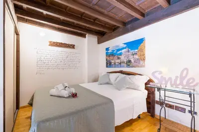 a bedroom with two beds with white sheets at Loft Trastevere 2 floors in Rome