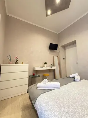a bedroom with two beds and a desk and a tv at il borghetto antico in Rome