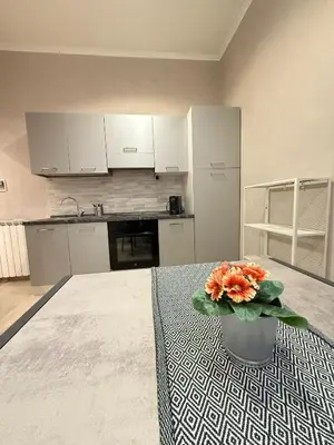 a kitchen with a vase of flowers on a table at il borghetto antico in Rome