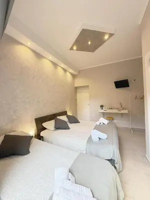 a hotel room with two beds and a television at il borghetto antico in Rome