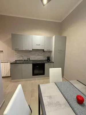 a kitchen with white appliances and a table and chairs at il borghetto antico in Rome