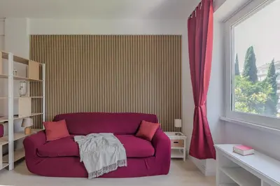 a living room with a purple couch and a window at Aura in Rome