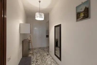 a hallway with a mirror and a chandelier at Aura in Rome