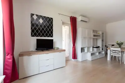 a living room with a tv on a white cabinet at Aura in Rome