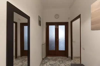 a hallway with two doors and a mirror at Aura in Rome