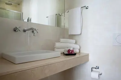 a bathroom with a sink and a mirror and towels at Chic&Town Luxury Rooms Piazza del Popolo in Rome