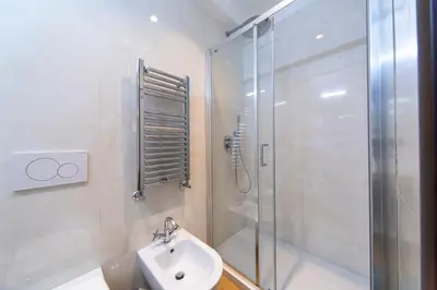 a white bathroom with a shower and a sink at Chic&Town Luxury Rooms Piazza del Popolo in Rome