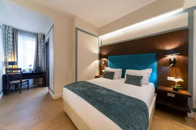 a hotel room with a large bed and a desk at Chic&Town Luxury Rooms Piazza del Popolo in Rome