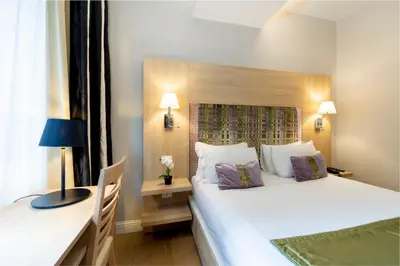 a hotel room with a large bed and a desk at Chic&Town Luxury Rooms Piazza del Popolo in Rome