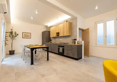 a kitchen and dining room with a table and chairs at Borgo Felix - Authentic Roman Living in Quadraro in Rome