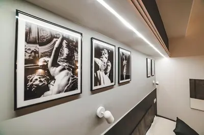 a hallway with four framed pictures on a wall at Monteverde Vatican in Rome