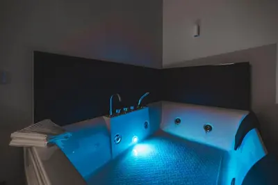 a bathroom with a blue tub with lights in it at Monteverde Vatican in Rome