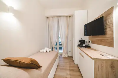 a bedroom with a bed and a flat screen tv at Monteverde Vatican in Rome