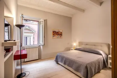 a bedroom with a bed and a window at Agnello Apartment in Rome