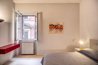 a bedroom with a bed and a window at Agnello Apartment in Rome
