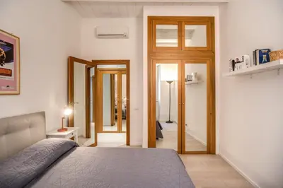 a bedroom with a bed and a door to a hallway at Agnello Apartment in Rome