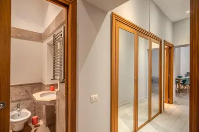 a bathroom with a toilet and a sink at Agnello Apartment in Rome