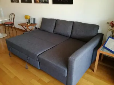 a gray couch in a living room with a table at Art Loft Penthouse near Trastevere in Rome