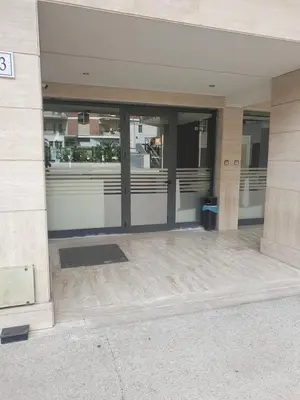 an entrance to a building with glass doors at Art Loft Penthouse near Trastevere in Rome