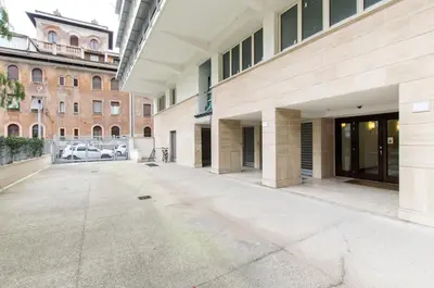 an empty parking lot in a building with buildings at Art Loft Penthouse near Trastevere in Rome